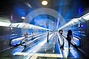 View to wide blue corridor with escalators