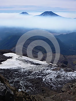 View of tolhuaca and lonquimay volcano peaks from sierra nevada in chile photo