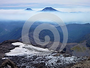 View of tolhuaca and lonquimay volcano peaks from sierra nevada in chile photo