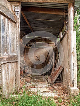 View of the tools and assorted objects in a rustic and very deteriorated small shed