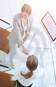 View from the top.business woman shaking hands with employee