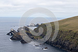 Grassy cliffs with rocks at Hermaness national nature reserve, Shetland photo