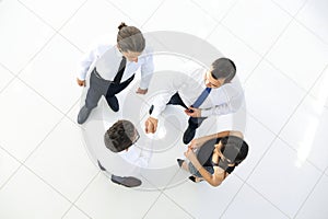 View from the top. colleagues shaking hands in office lobby.