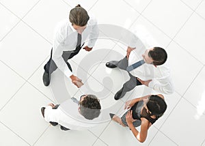 View from the top. colleagues shaking hands in office lobby.