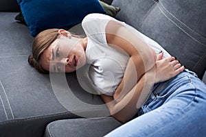 Woman curled up in fetal position