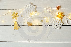View top of the desktop with the preparations of Christmas. Snowflakes, Christmas trees and garland
