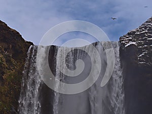 View of the top of famous waterfall SkÃ³gafoss (height 60m) located on the southern coast of Iceland in winter.