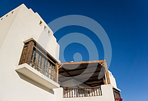 The view of top floor of house in the garden with balcony and roof