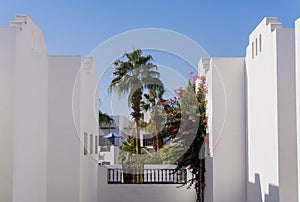 The view of top floor of house in the tropical garden with balcony and roof