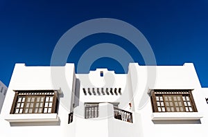 The view of top floor of house in the tropical garden with balcony and roof