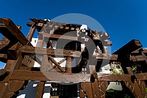 The view of top floor of house in the tropical garden with balcony and roof