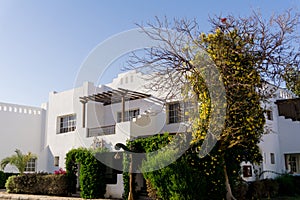 The view of top floor of house in the tropical garden with balcony and roof