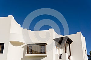 The view of top floor of house in the tropical garden with balcony and roof