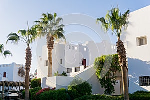 The view of top floor of house in the tropical garden with balcony and roof