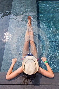 View from the top of a girl relaxing in the swimming pool