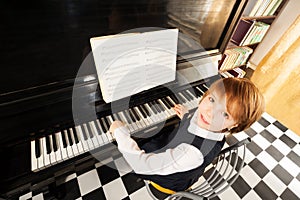 View from top of girl in uniform playing piano