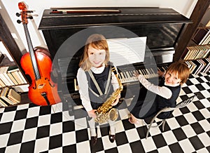 View from top of girls play on music instruments