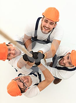 View from the top.a group of workers pulling a rope