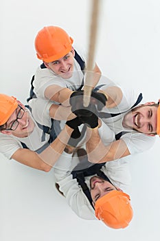 View from the top.a group of workers pulling a rope