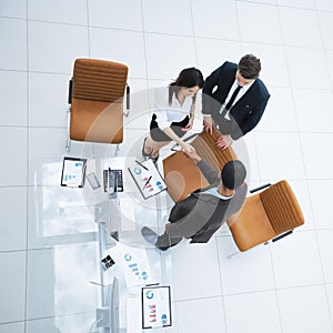 View from the top.the handshake business partners at a business meeting