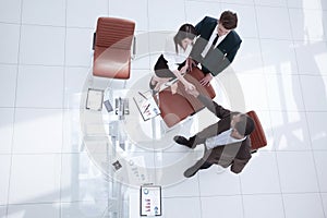 View from the top.the handshake business partners at a business meeting