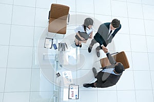 View from the top.the handshake business partners at a business meeting