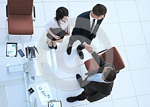 View from the top.the handshake business partners at a business meeting