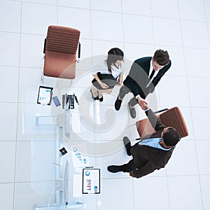 View from the top.the handshake business partners at a business meeting