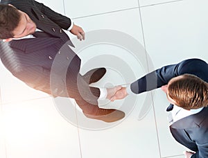 View from the top.handshake, business partners ,isolated on white background.