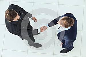 View from the top.handshake, business partners ,isolated on white background.