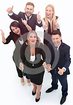 View from the top.happy business team holding up a thumbs up.