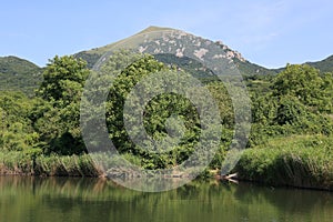 A view of the top of Mount Beshtau from its slope near small unnamed pond in Pyatigorsk, Russia