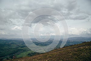 A view from the top of the mountain Gemba or Gimba down to the meadow and village Pilipec, Carpathian mountains, Ukraine