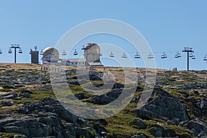 View at the top of the mountains of the Serra da Estrela natural park, tower buildings with dome and cable car railway circuit,