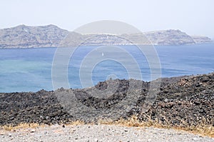 View from the top of Nea Kameni to island Terasia and city Manolas, Greece