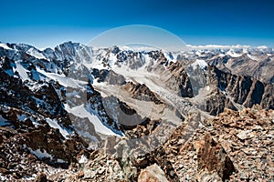 View from the top of Pik Uchitel peak with cross. Ala Archa Alpine National Park Landscape near Bishkek, Tian Shan Mountain Range
