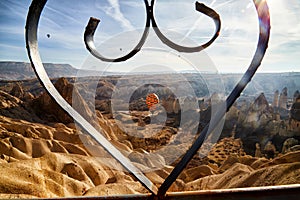 View from top place on the strange landscape in the Cappadocia valley with yellow mountains, rocks and hills and blue sky with