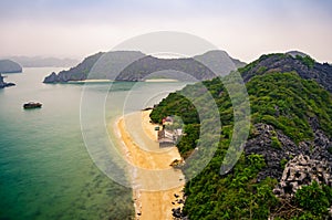 View from the top of an small island with deserted beach, clear sea and beautiful landscape with karst stone islands in the water