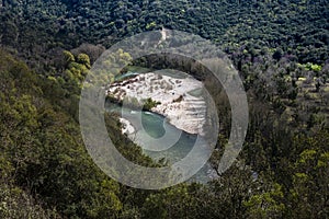 View from the top to the cascades in the jungle. River meandering through forested landscape. Panoramic view from above of