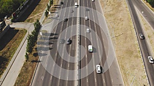 View from the top to the highway. 4K aerial drone shooting of a multi-lane road with moving vehicles. Car traffic in a