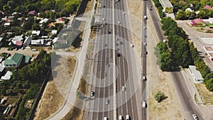 View from the top to the highway. 4K aerial drone shooting of a multi-lane road with moving vehicles. Car traffic in a