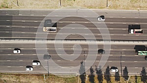 View from the top to the highway. 4K aerial drone shooting of a multi-lane road with moving vehicles. Car traffic in a