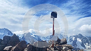 View of the top of Uchitel Peak in the mountains of Kyrgyzstan. A shovel in the rocks. Ala Archa National Park. Active summer