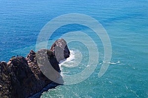 View from the top of the wall of Alanya fortress to surrounding cliffs and rocks and azure mediterranean sea