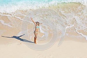 View from top of woman in bikini on sand beach