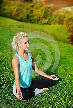 View from top of a woman sitting in siddhasana yoga pose