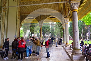 Tourists in Topkapi Palace courtyard on rainy spring day Istanbul Turkey