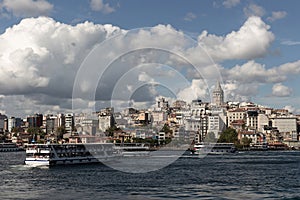 View of tour boats on Golden Horn area of Bosphorus in Istanbul. Galata tower and Beyoglu district are in the background.