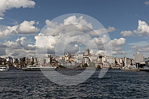 View of tour boats on Golden Horn area of Bosphorus in Istanbul. Galata tower and Beyoglu district are in the background.