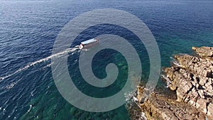 View of a tourist boat sailing near rocky beach of the island of Mamula